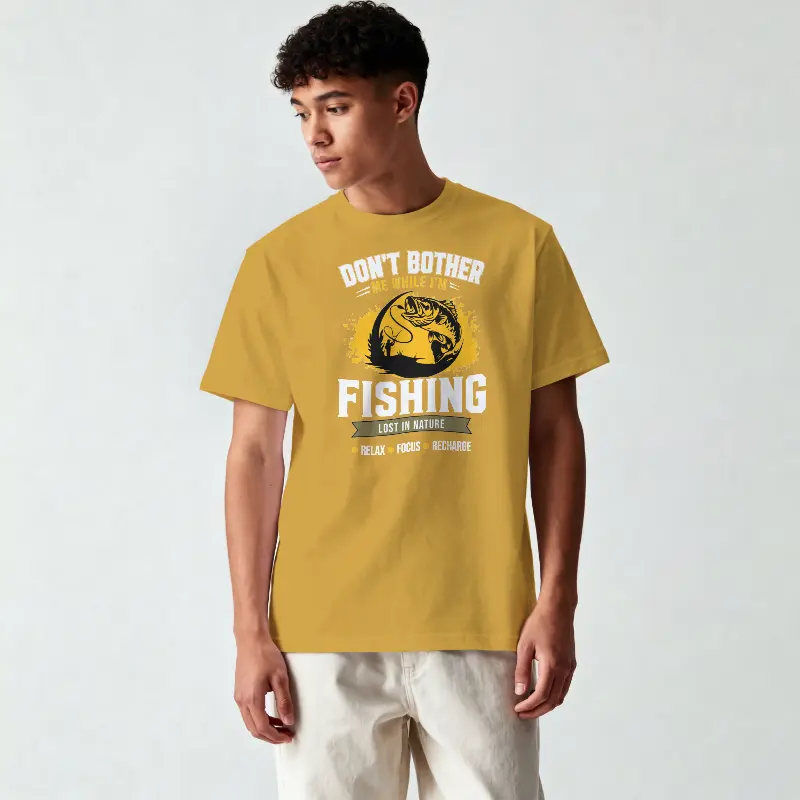 Don't Bother I'm Fishing 180 GSM premium graphic T-shirt featuring a fishing-themed design on a mustard yellow tee.